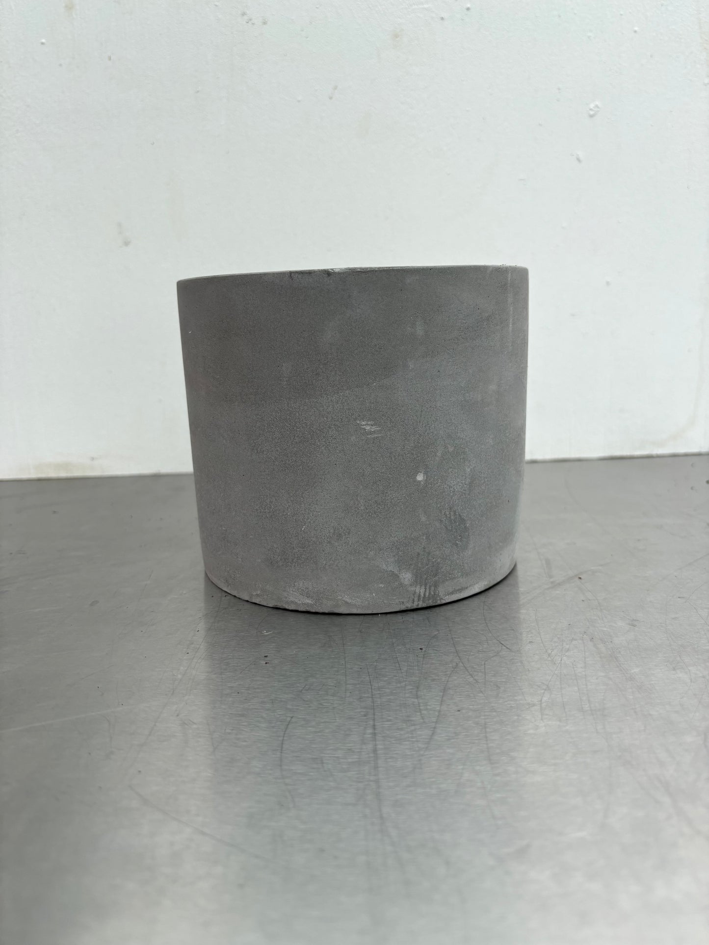 12 cm Grey Concrete Pot with smooth matte finish, ideal for modern indoor plant decor in home or office settings.
