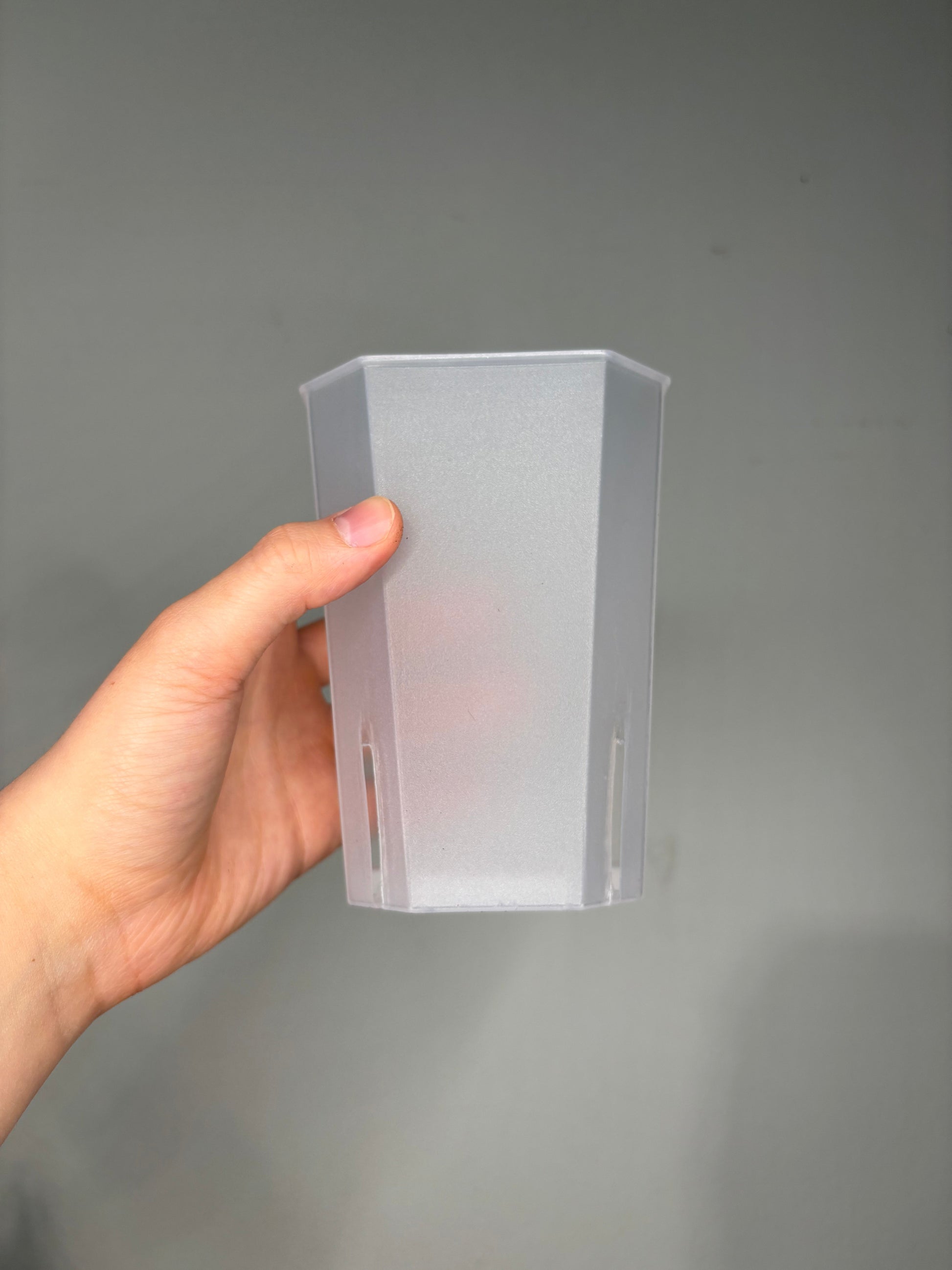 Large Transparent planter pot, 12x10cm shown empty with vertical drainage slits, ideal for rare tropical houseplants.