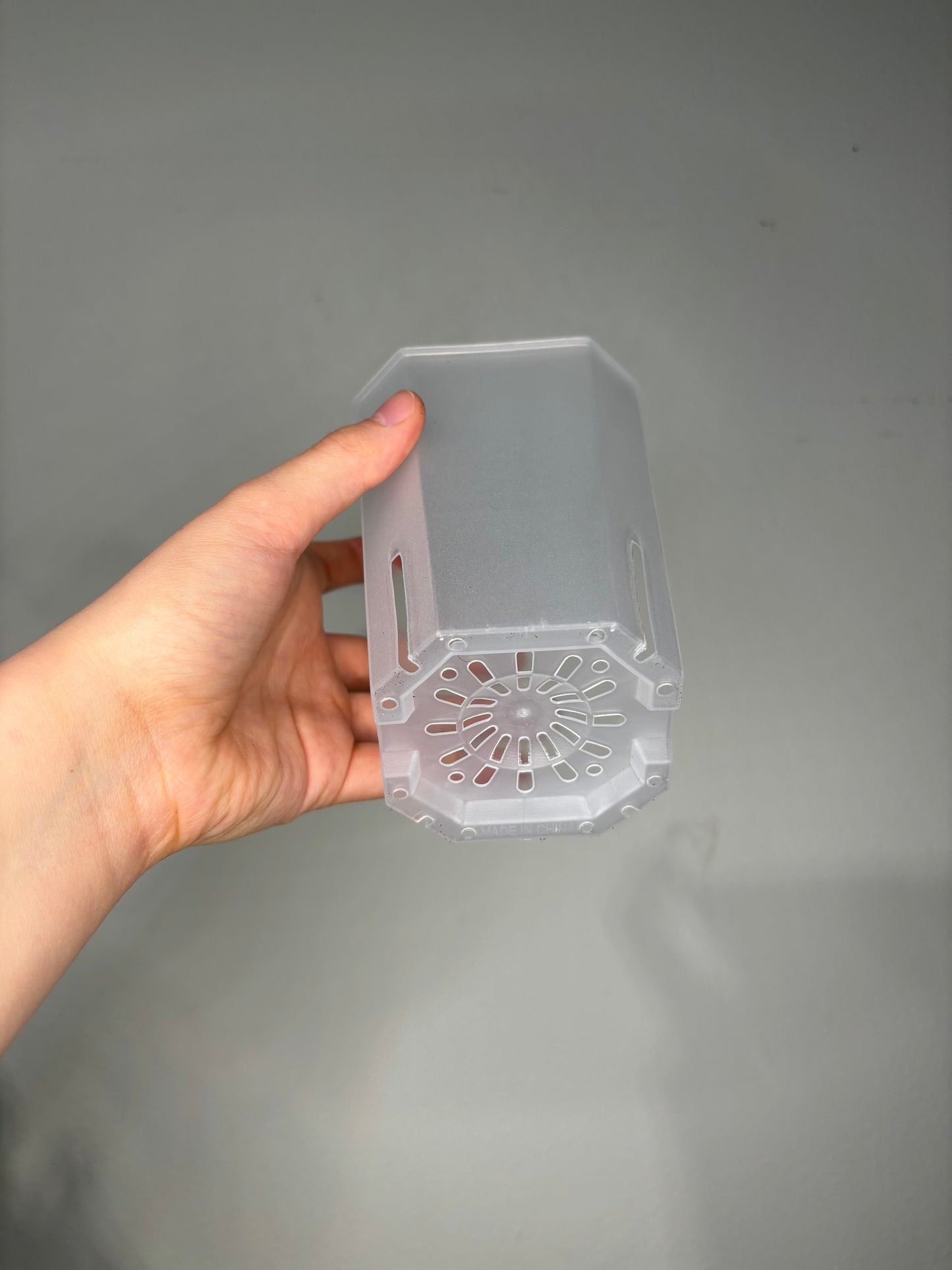 Bottom view of Large Transparent planter pot, 12x10cm featuring advanced drainage holes for optimal root aeration.