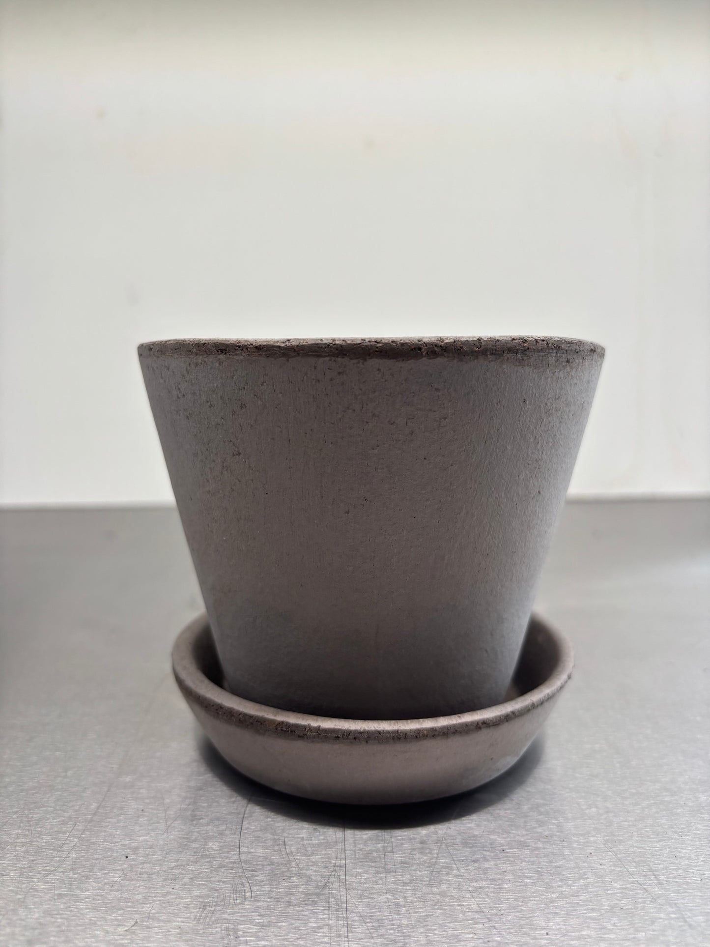 Bergs Clay pots, 11.5x12.5 cm in minimalist design, handcrafted from Italian terracotta with matching saucer for stylish plant display.