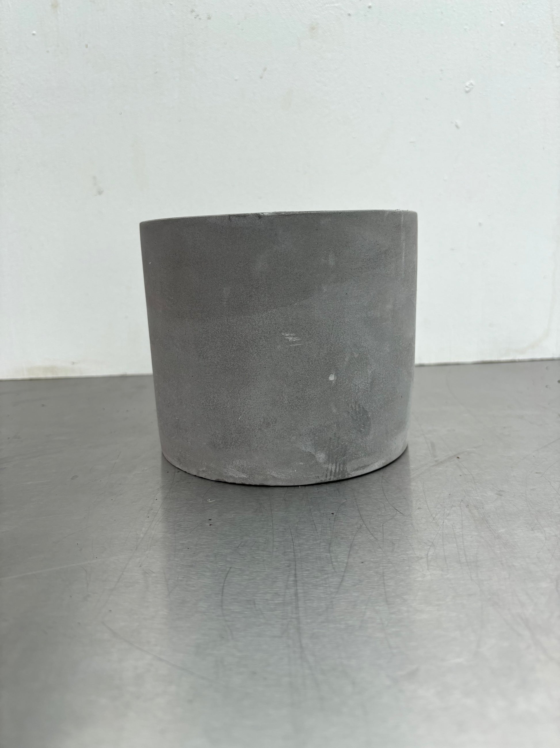 12 cm Grey Concrete Pot with smooth matte finish, ideal for modern indoor plant decor in home or office settings.