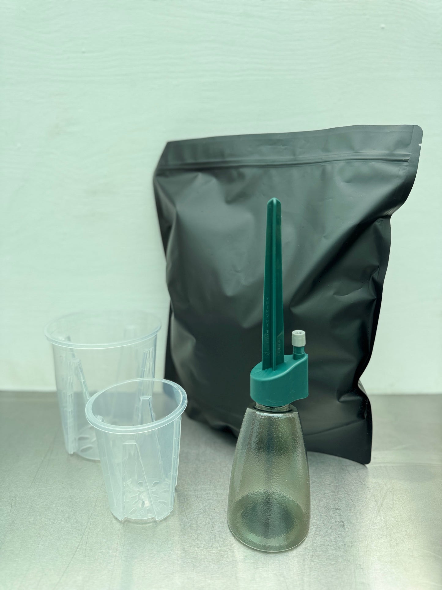 Summer Bundle Large kit featuring Aroid Soil Mix, two transparent planter pots, and a self-watering spike bottle for easy tropical plant care.